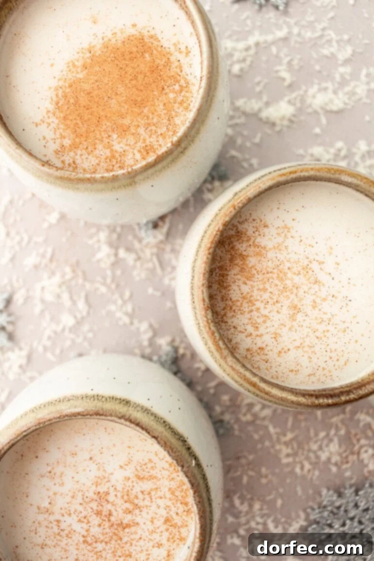 Snowman Soup: A Cozy Vanilla Milk Holiday Treat 11 Mugs of Warm Vanilla Milk with Sprinkled Cinnamon