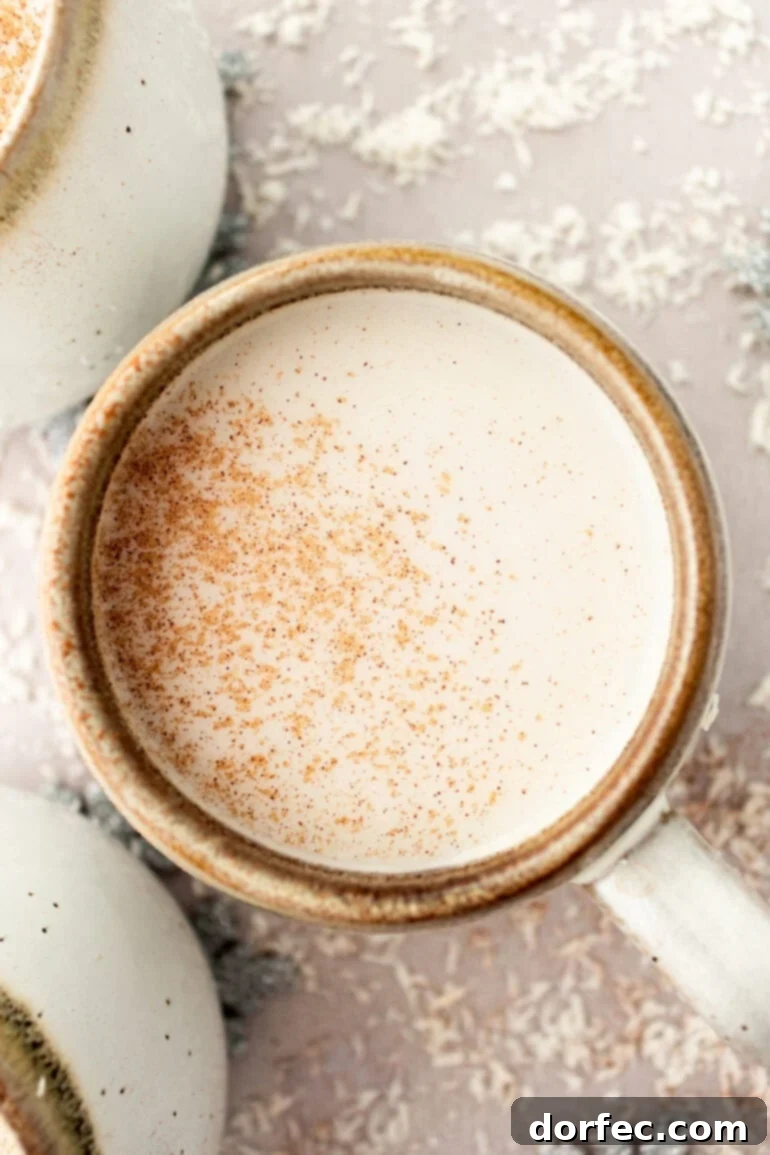 Snowman Soup: A Cozy Vanilla Milk Holiday Treat 4 Mug of Warm Vanilla Milk Topped with Cinnamon