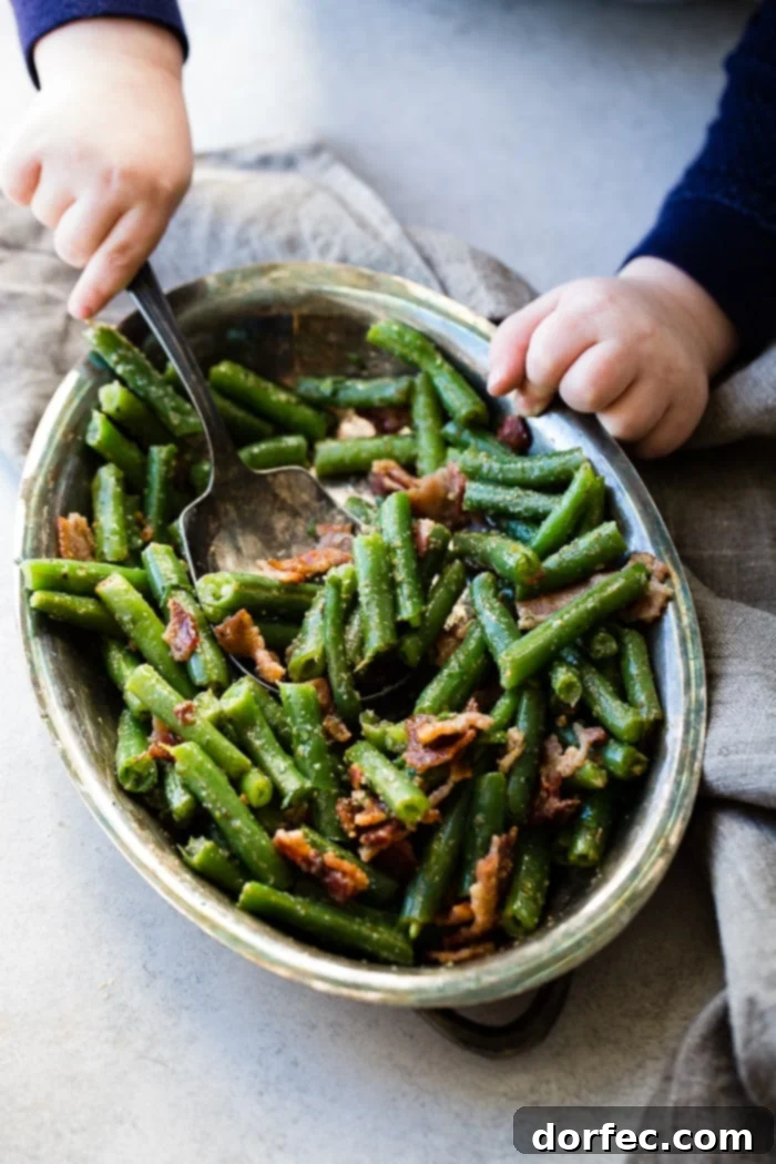 Child Reaching for Green Beans with Bacon