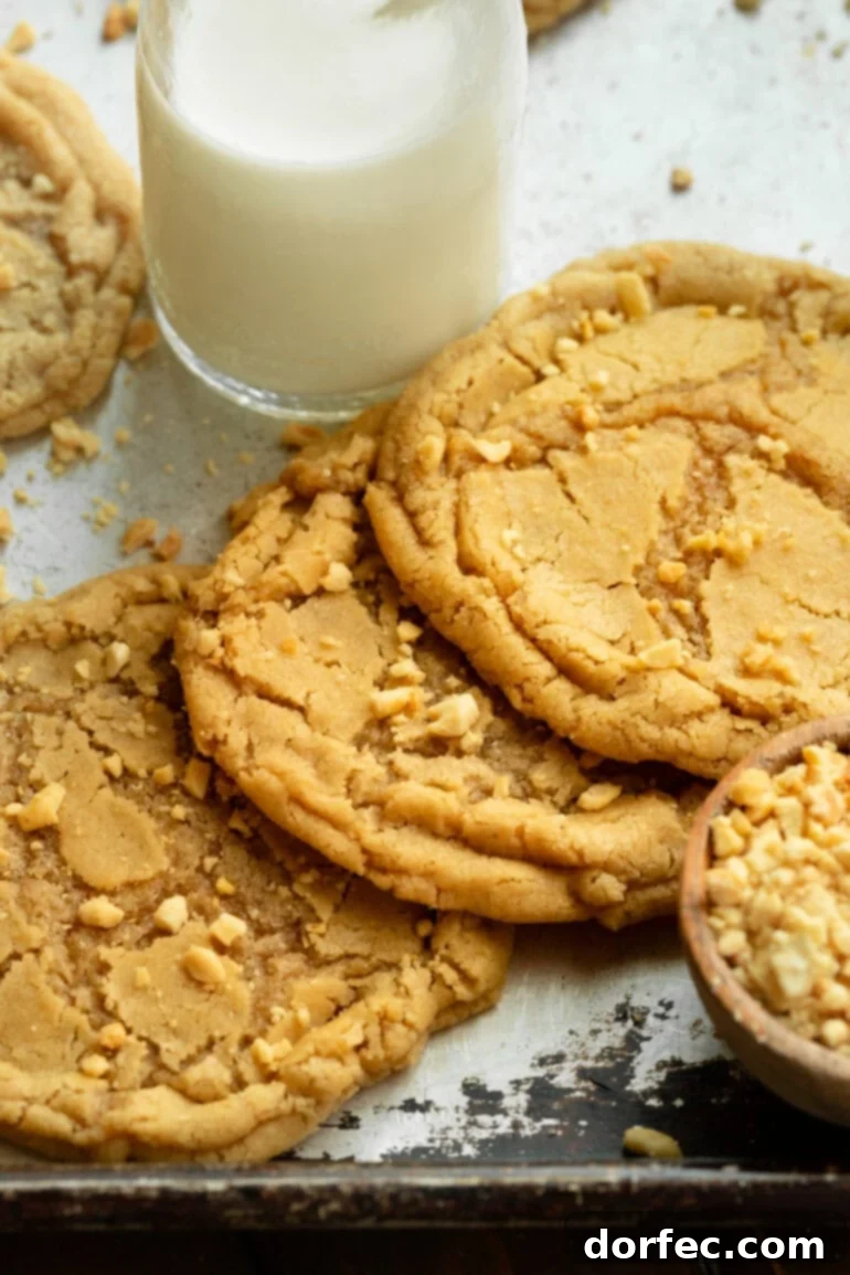 Bakery-Style Peanut Butter Dream Cookies 4 Several large, chewy peanut butter cookies with a glass of milk.