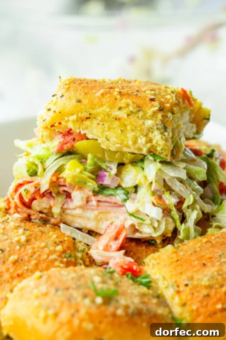 Italian slider on a bun with lettuce, tomatoes, Italian meats and dressing
