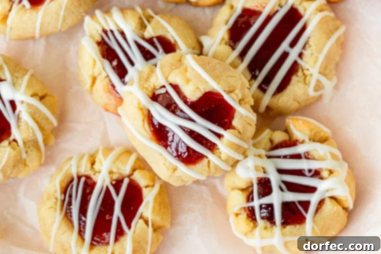 Buttery thumbprint cookies with strawberry and raspberry jam in heart-shaped centers.