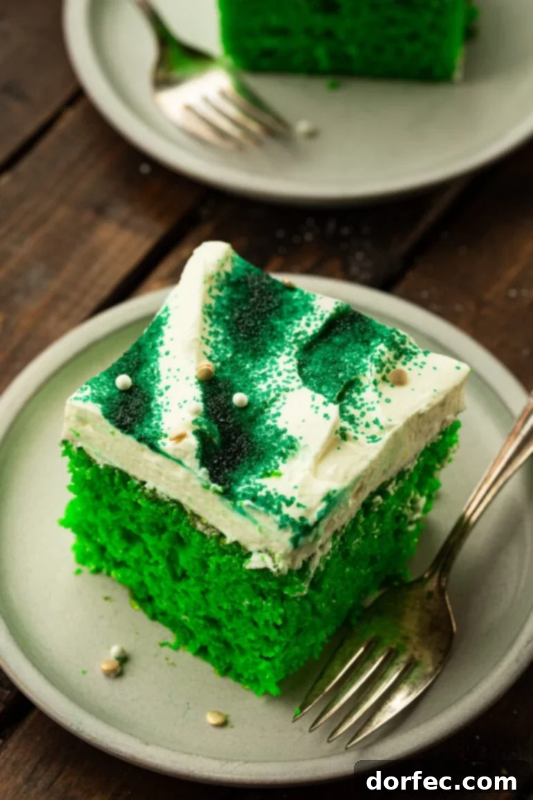 Shamrock Jello Poke Cake: A St. Patrick's Day Treat 5 Slice of Lime Jello Poke Cake on a Plate