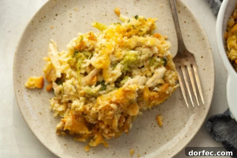 Effortless Chicken, Broccoli, and Rice Bake 3 A serving of Chicken Broccoli Rice Casserole on a plate with a fork