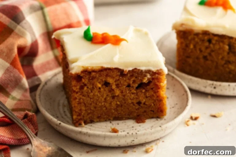 A slice of moist carrot cake with cream cheese frosting