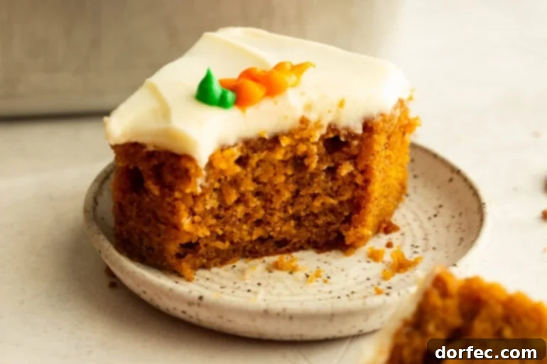 A slice of carrot cake with a bite taken out