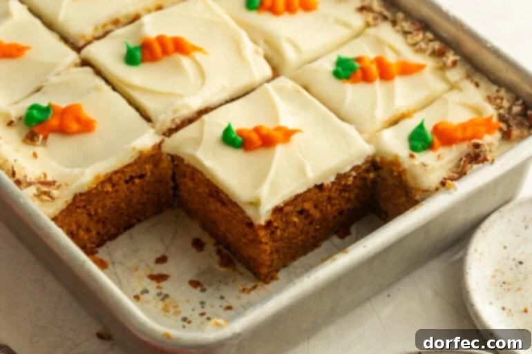 A baking pan with carrot cake slices and cream cheese frosting