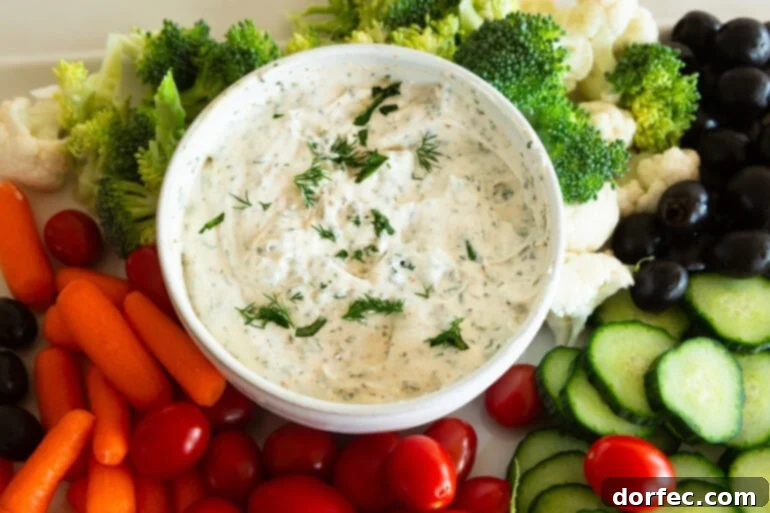 Creamy Herb and Garlic Vegetable Dip 2 Creamy garlic herb veggie dip in a bowl with dipping vegetables