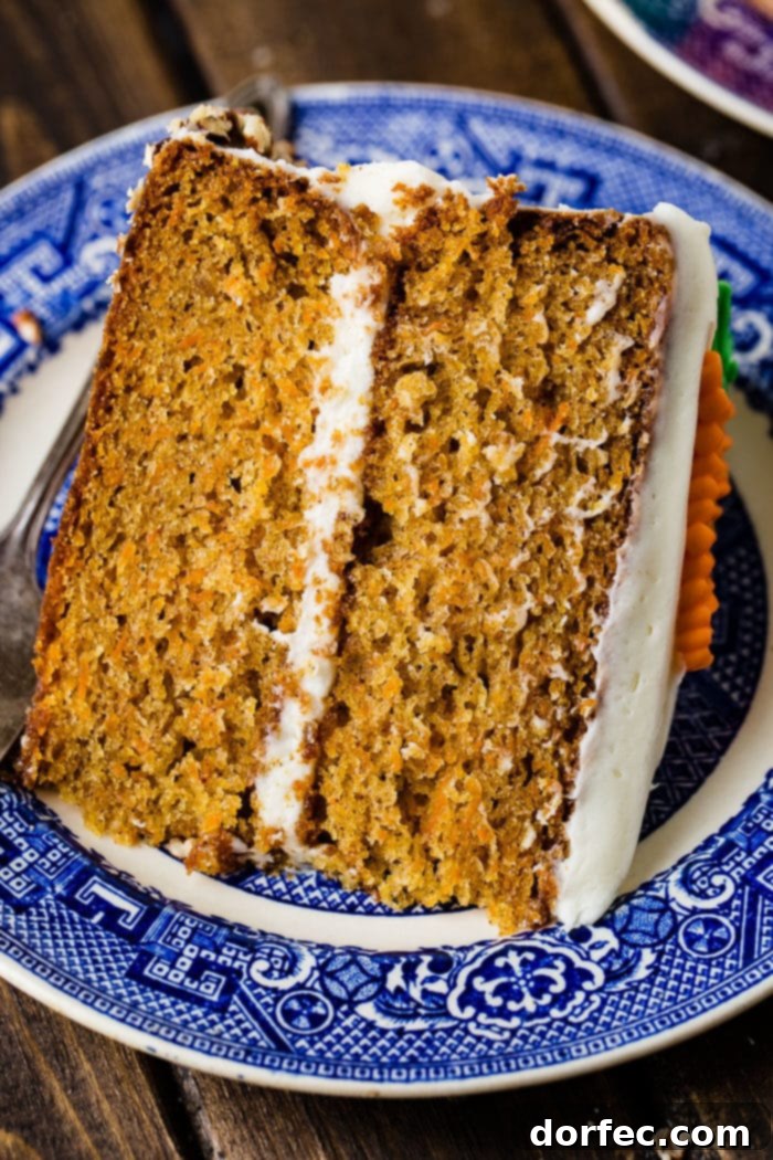 Ultimate Carrot Cake: Unbelievably Moist and Frosted to Perfection 4 Slice of two-layer carrot cake on a plate
