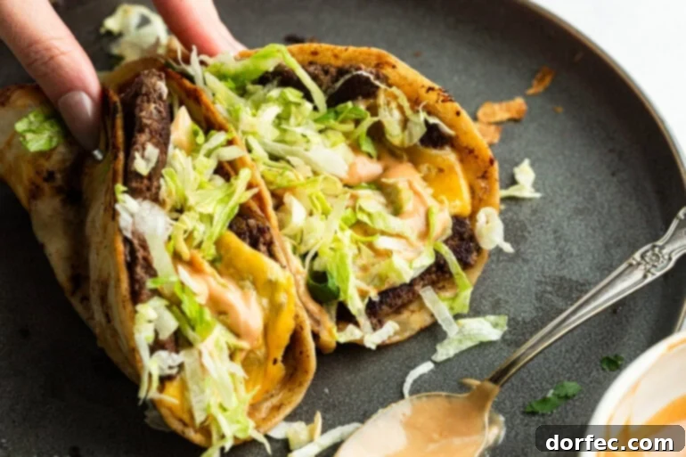 Hand holding a Smash Burger Taco