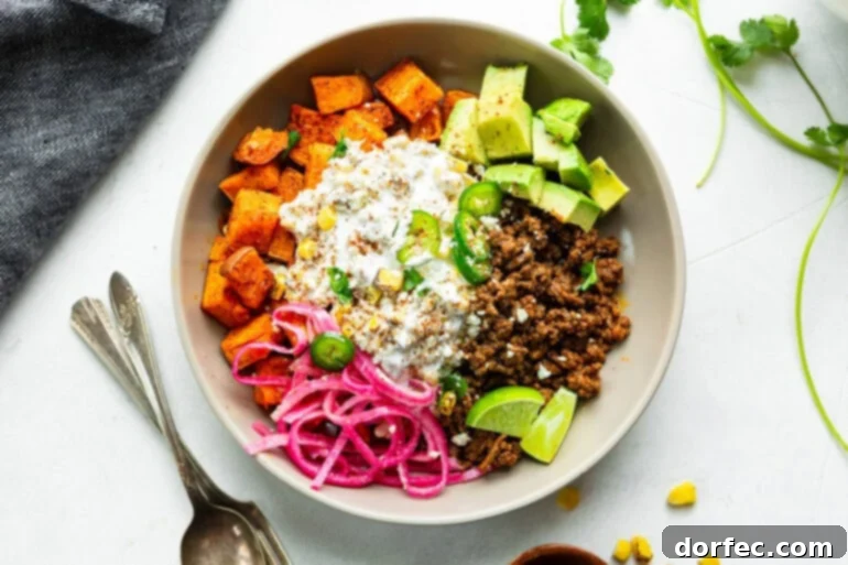 Ground beef sweet potato bowl with elote, avocado, and pickled red onions
