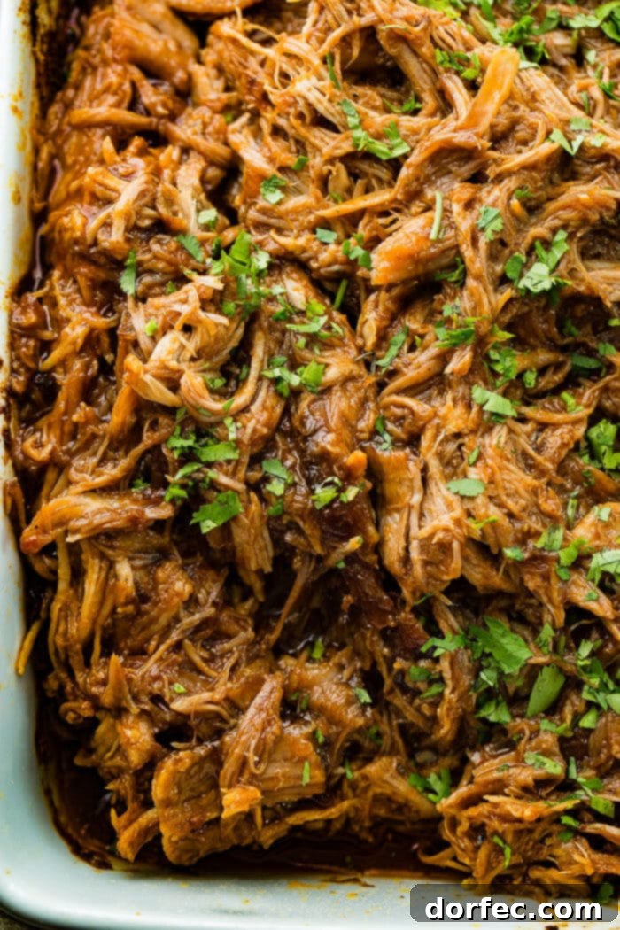 An entire pan of delicious shredded Cafe Rio sweet pork copycat recipe, generously topped with chopped cilantro.