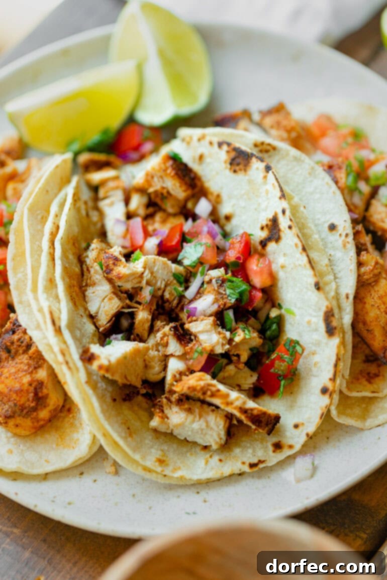 A vibrant photo of a grilled chicken taco generously topped with fresh, colorful pico de gallo, capturing its smoky essence.