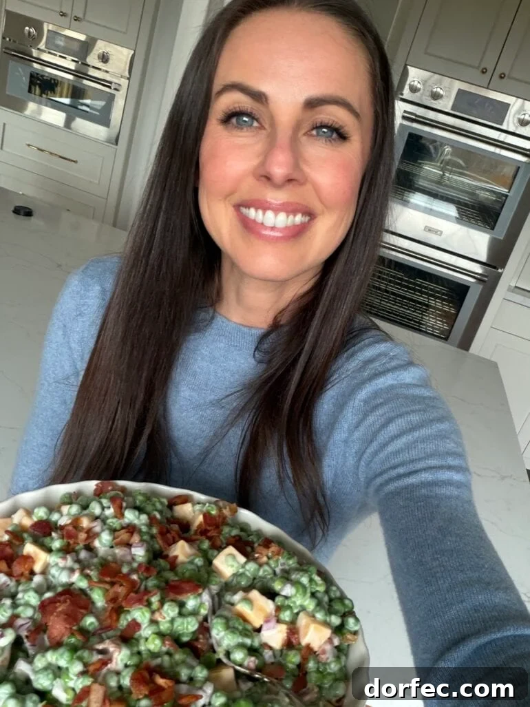 carrian holding a large serving bowl of English pea salad