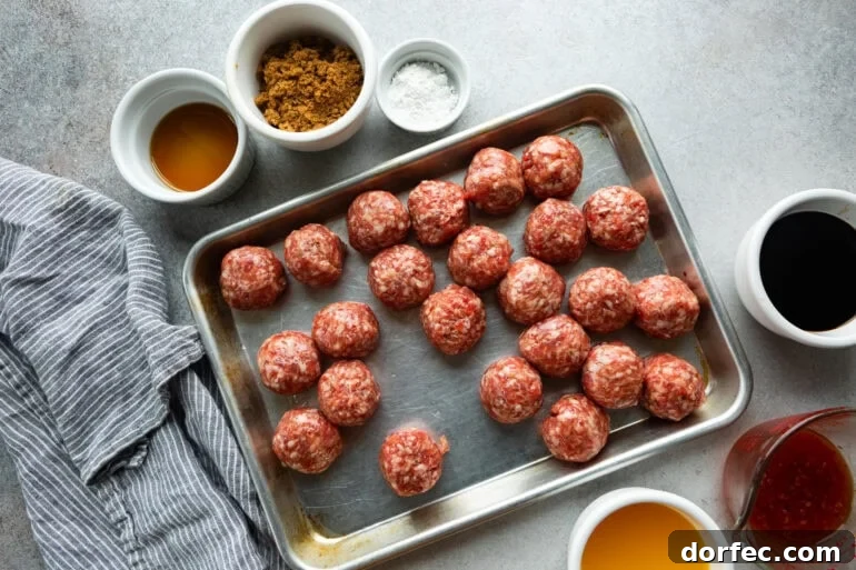 all the ingredients for sticky korean meatballs with raw meatballs on a baking sheet, brown sugar, oil, salt, etc all in separate small bowls