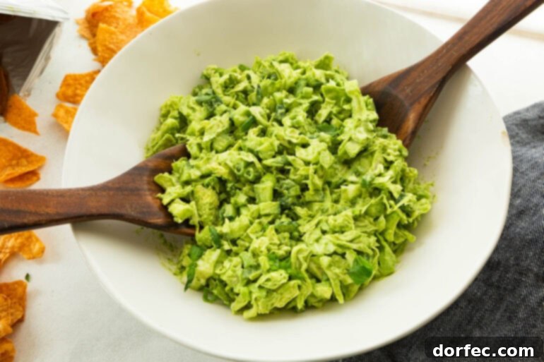 A top-down view of the green goddess salad in a large bowl, showcasing its vibrant green color and texture.