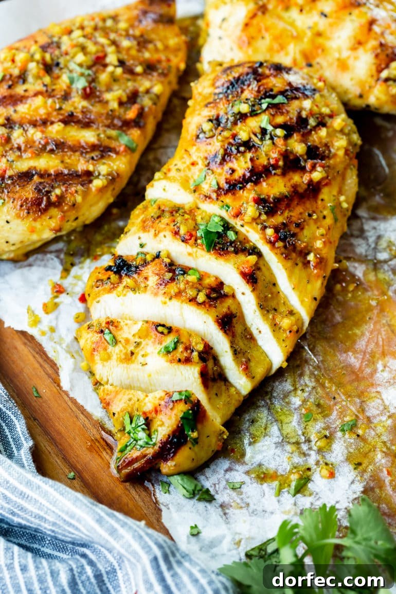 How Long to Grill Chicken Breast for Juicy Results Every Time 5 a photo of a golden grilled chicken breast that has been sliced into about half inch slices.