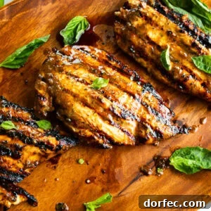 How Long to Grill Chicken Breast for Juicy Results Every Time 8 several grilled chicken breasts with basil leaves scattered about it