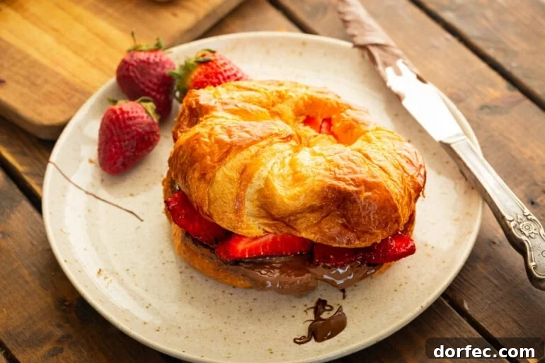 Grilled Croissants with Strawberry and Nutella Filling 6 A flaky croissant sandwich with nutella, strawberries, and a grilled croissant with butter.