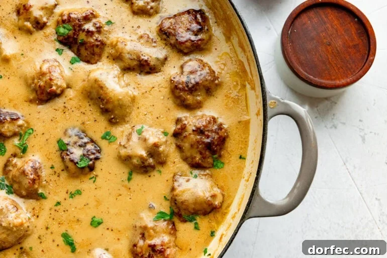 Authentic Swedish Meatballs with Creamy Gravy 3 a large dutch oven full of Swedish meatballs simmering in a creamy gravy