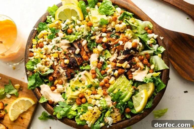 a large wooden bowl full of grilled chicken salad with southwest ranch dressing