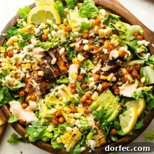 a large wooden bowl full of grilled chicken salad with southwest ranch dressing